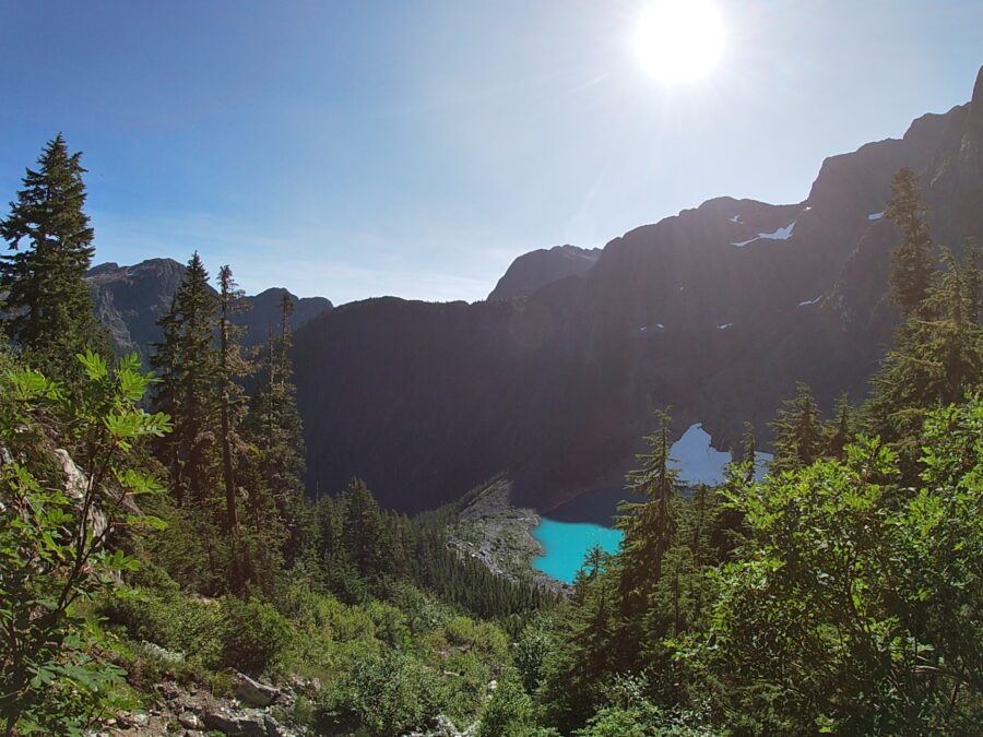 Berg lake surrounded by mountains and trees in Strathcona Park on Vancouver Island