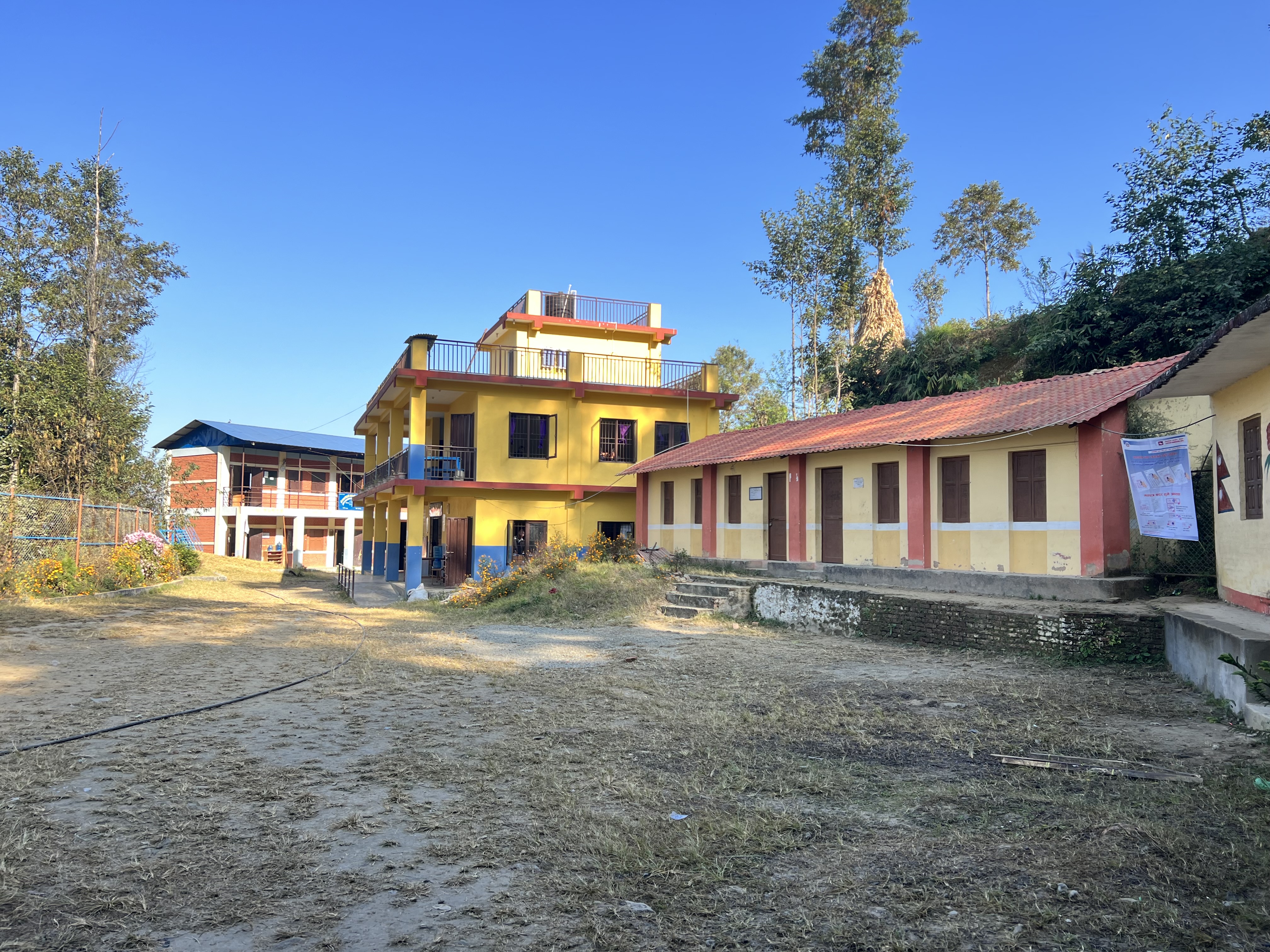 The school yard and some school buildings, at the local school in Patlekhet, Nepal. 