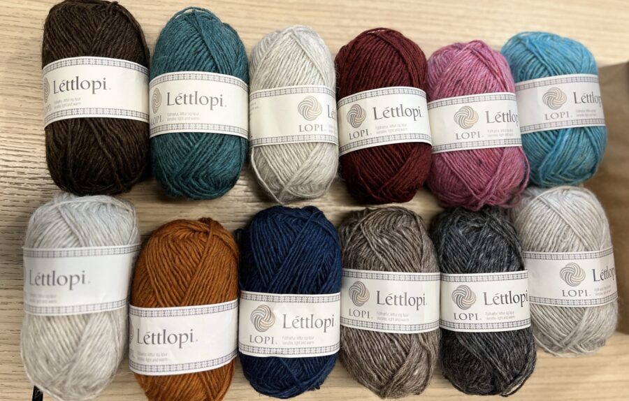 A collect of 12 balls of Icelandic wool called Lettlopi of various colours.