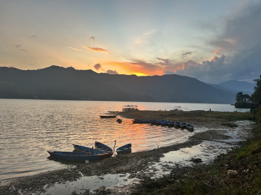 Phewa Lake in Pokhara Nepal, at sunset with row boats in the foreground