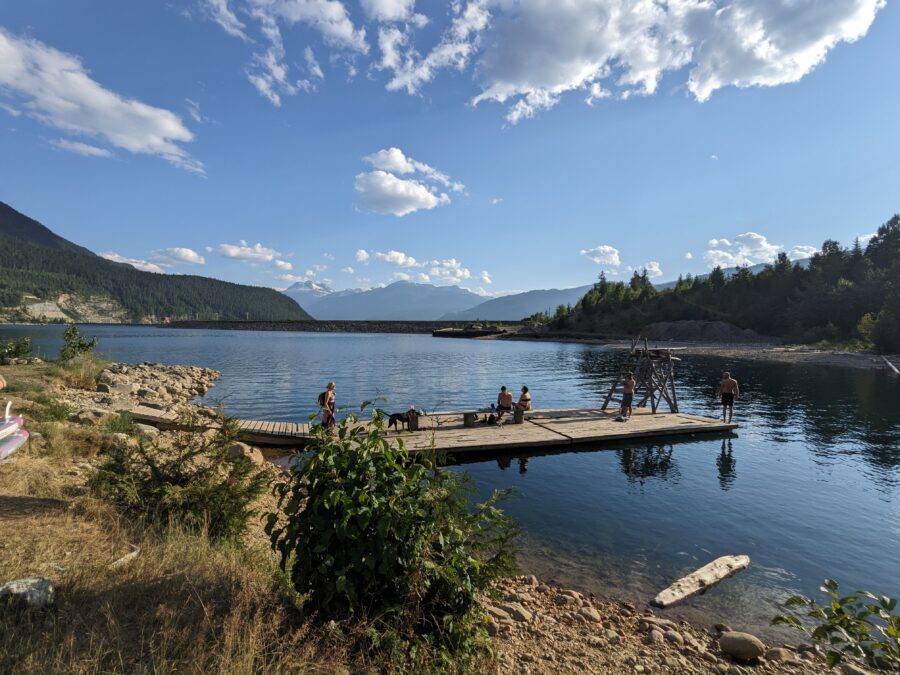 A dock in Lake Revelstoke with people on it. 