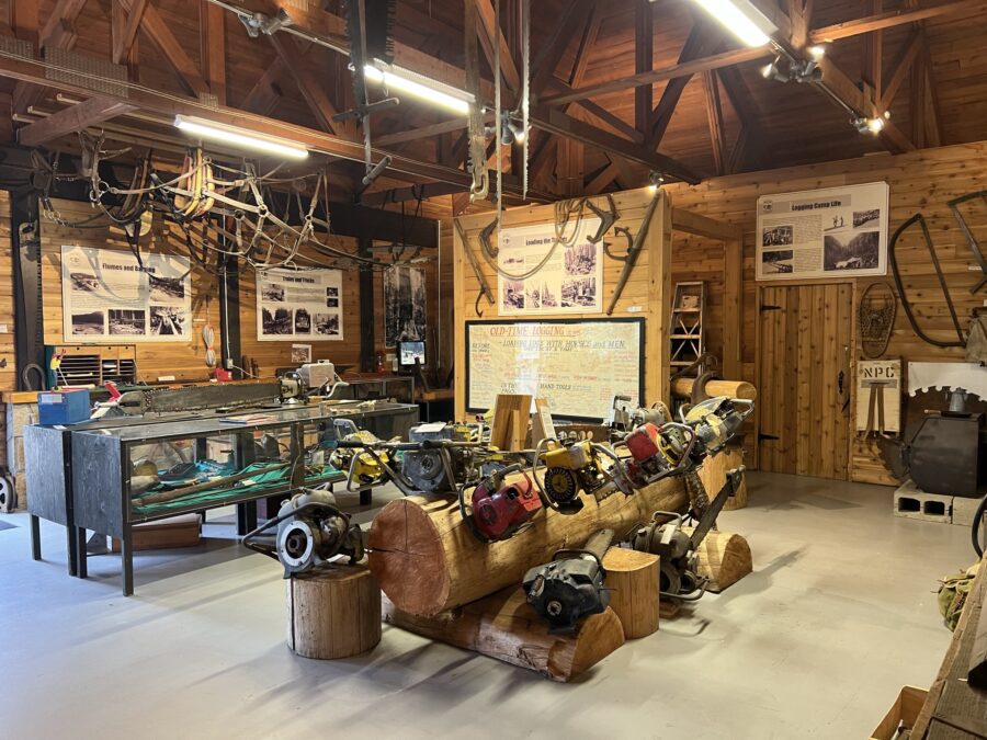 A variety of chainsaws in the middle of the room in the BC Interior Forestry Museum