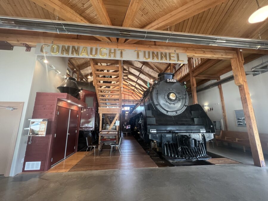 An old, black train under a sign that says "Connaught Tunnel"