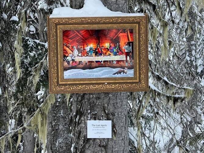 A painting titled "The Last Apres" with a bit of snow on it, hung on a tree on the Revelstoke Mountain Resort ski hill. 