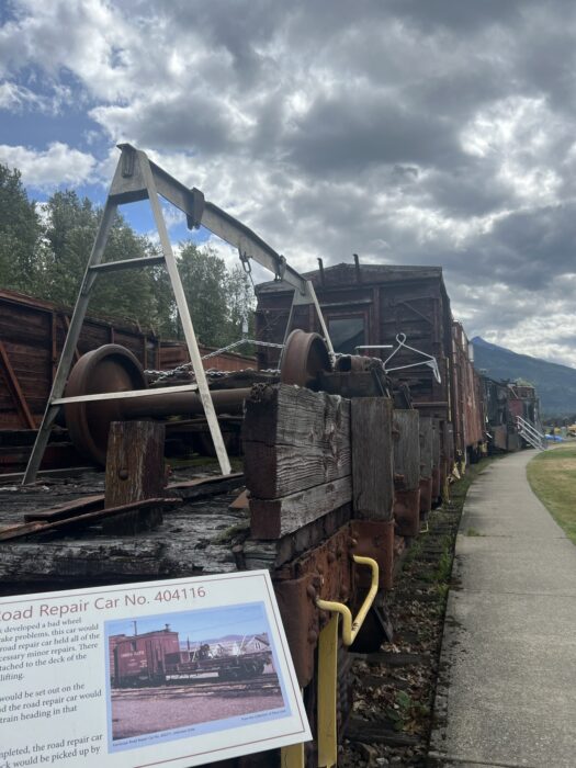 A Road Repair Train Car, with an information sign, in the trainyard of the Revelstoke Railway Museum