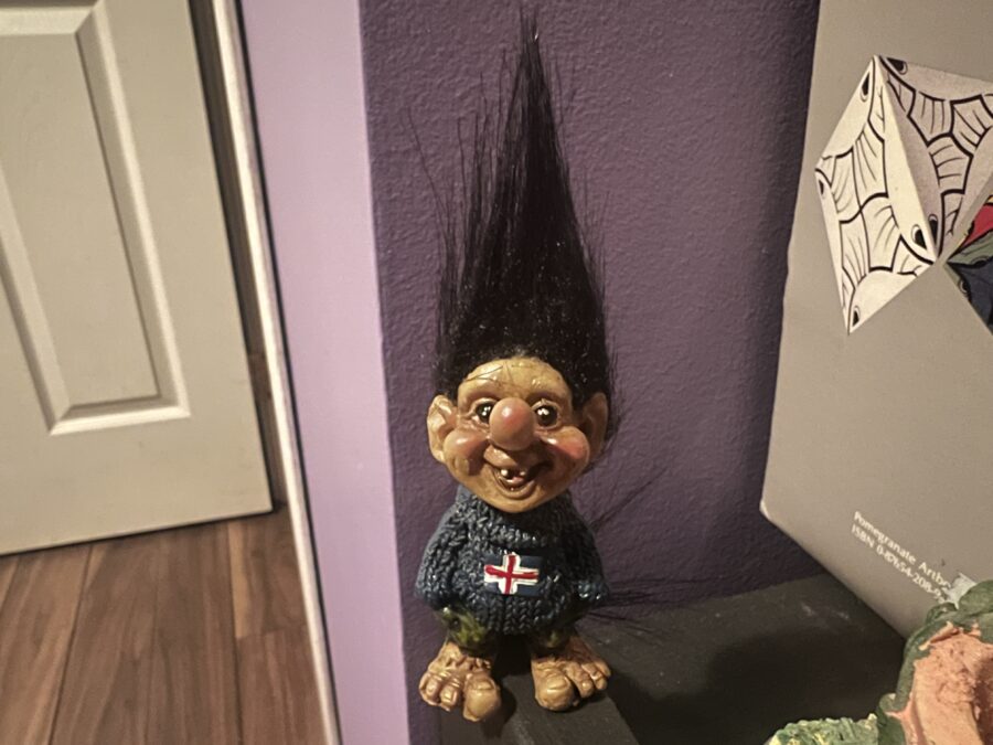 An elf figurine with a blue sweater on with an icelandic flag, and tall hair