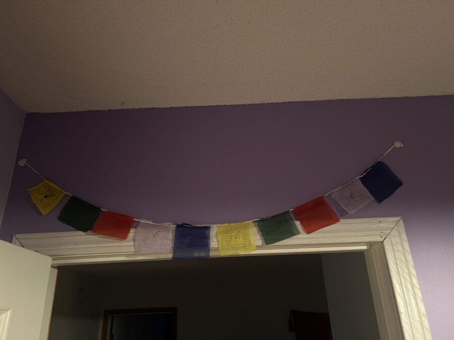 Tibetan prayer flags (a gift from Nepal) hanging above a doorway.