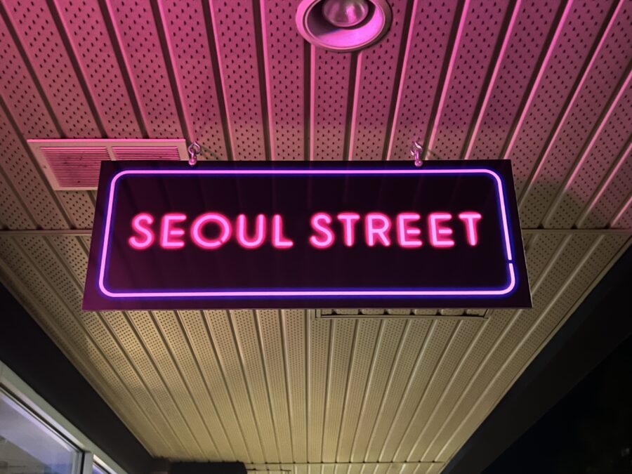 A pink neon sign that reads "Seoul Street"