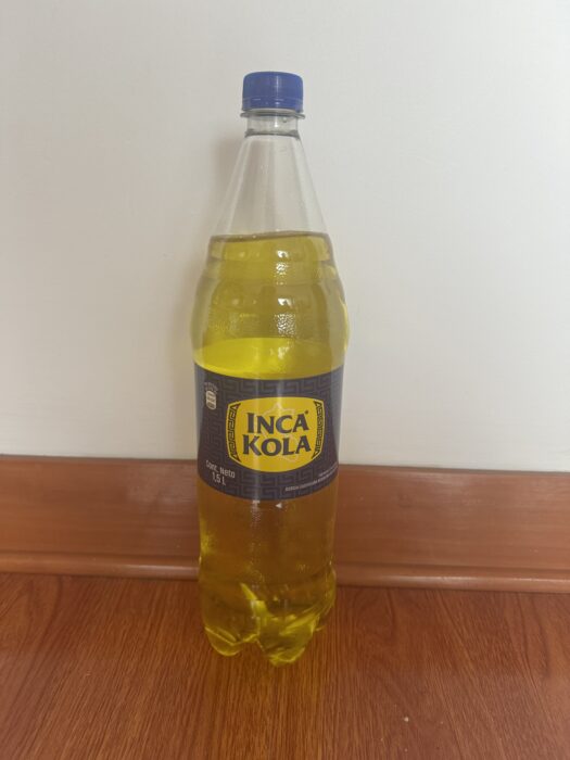 A bottle of Inca Kola, a vibrant yellow Peruvian soda