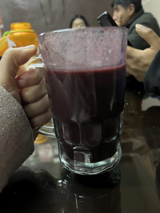 A glass of api, a hot Peruvian drink made of purple corn