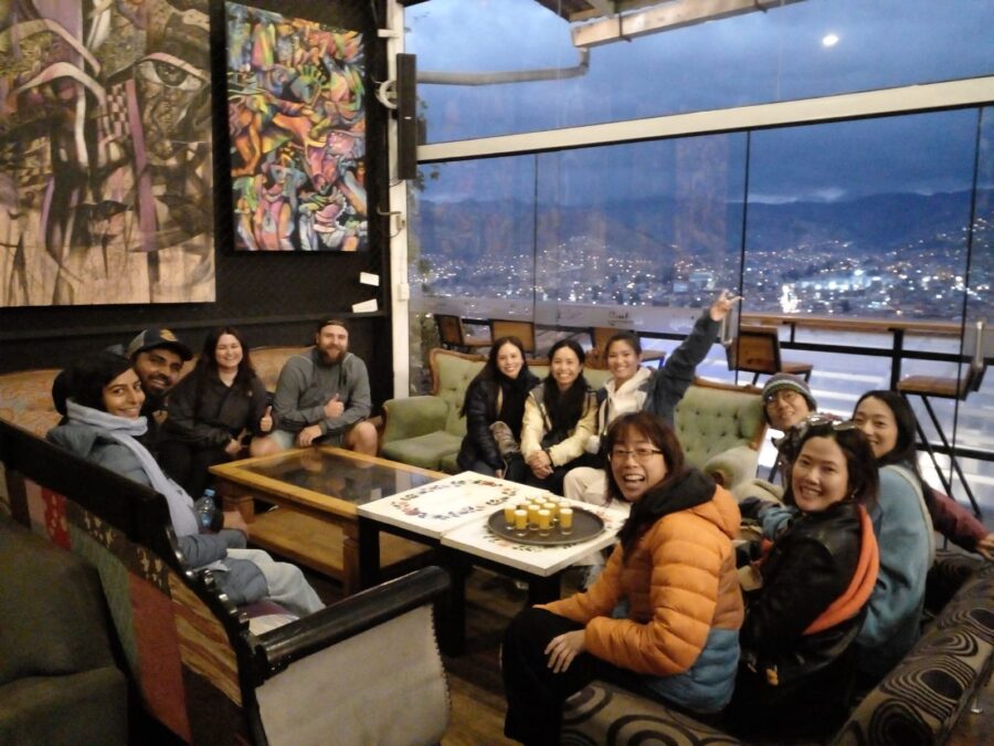 A walking tour group enjoying Maracuya Sours at the end of a tour in Cusco, Peru